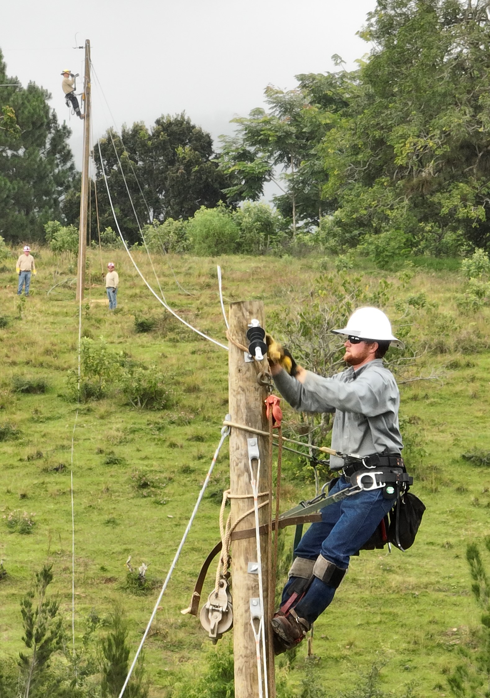 Seth working on power poles in the village 